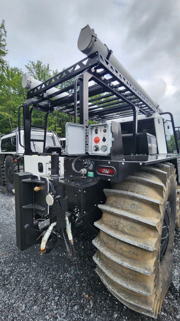 Side detail of a Fat Truck Pickup amphibious all-terrain vehicle showing roof rack and hot sticks for electric utility work