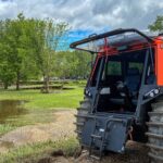 RCMP FAT TRUCK® Search and Rescue vehicle with open cab door positioned near flooded ground in Swan River, Manitoba.